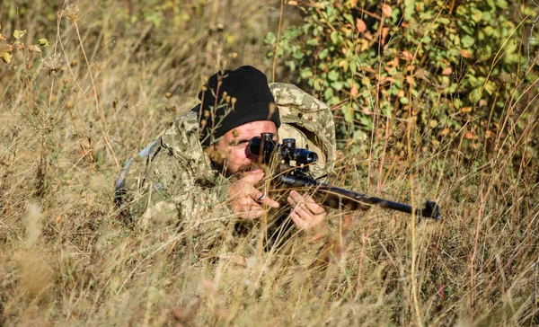 Hunting skills and weapon equipment. How turn hunting into hobby. Bearded man hunter. Army forces. Camouflage. Military uniform fashion. Man hunter with rifle gun. Boot camp. Military equipment