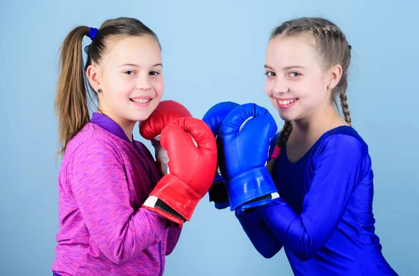 punching knockout. Childhood activity. Fitness. energy health. Sport success. Friendship. Happy children sportsman in boxing gloves. workout of small girls boxer in sportswear. Energy inside them