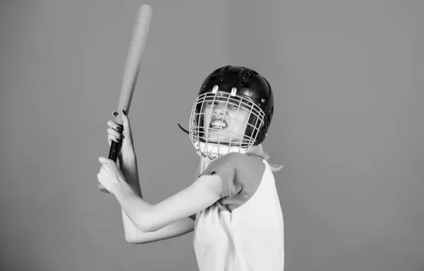 Ready repel attack. Woman enjoy play baseball game. Woman in baseball sport. Girl confident pretty blonde wear baseball helmet and hold bat on blue background. Baseball female player concept