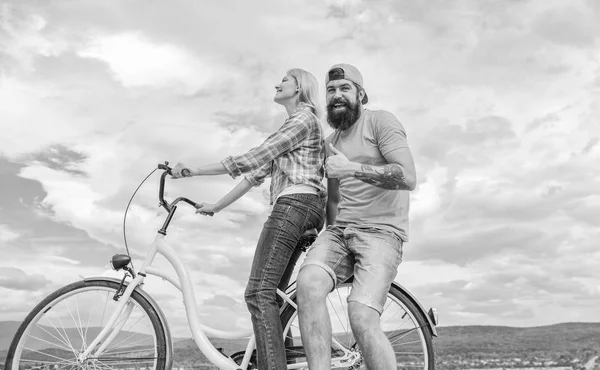 Man and woman spend active leisure with bike. Couple in love date outdoors cycling. Bike rental or bike hire for short periods of time. Date ideas. Couple with bicycle romantic date sky background