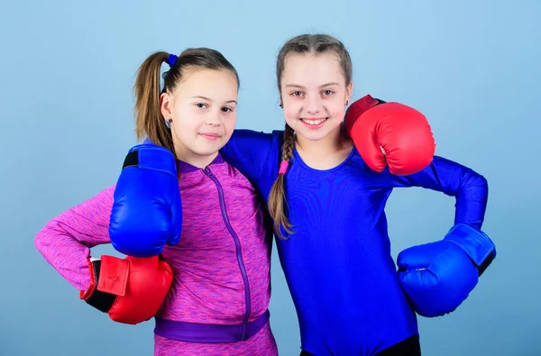 Everything is possible. Happy children sportsman in boxing gloves. workout of small girls boxer in sportswear. punching knockout. Childhood activity. Fitness diet. energy . Sport success. Friendship