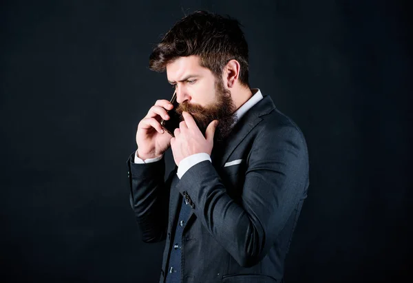 Mobile call concept. Mobile call conversation. Mobile negotiations. Businessman well groomed mature man hold smartphone. Guy call friend stand black background. Man formal suit call someone