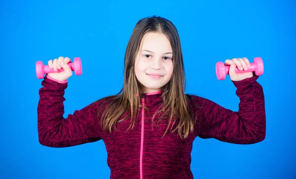 Weight lifting for muscules. Childhood activity. Fitness diet for energy health. workout of small girl has dumbbell. Sport success. Happy child sportsman with barbell. sport activity. indoor activity — Stock Photo, Image