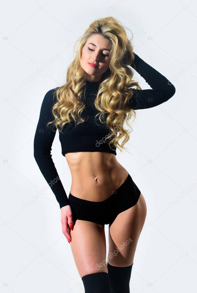 Sexy woman with long curly hair. Hair beauty of sensual girl. Perfect body shape. Sexy blond woman. Erotic lingerie and underwear. Fashion model with fit belly. Sexy reality. Stylish and sexy