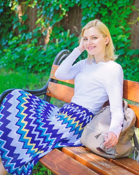 Time for yourself. Why you deserve break. Ways to give yourself break and enjoy leisure. Girl sit bench relaxing in shadow, green nature background. Woman blonde take break relaxing in park