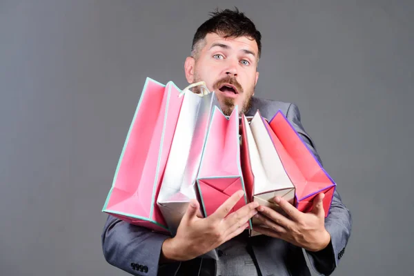 Can you imagine that. Telling friend about sales. bearded man in formal suit. stylish esthete with shopping bags, purchase. business. Big sale. heavy bags. real shopaholic. businessman in bow tie