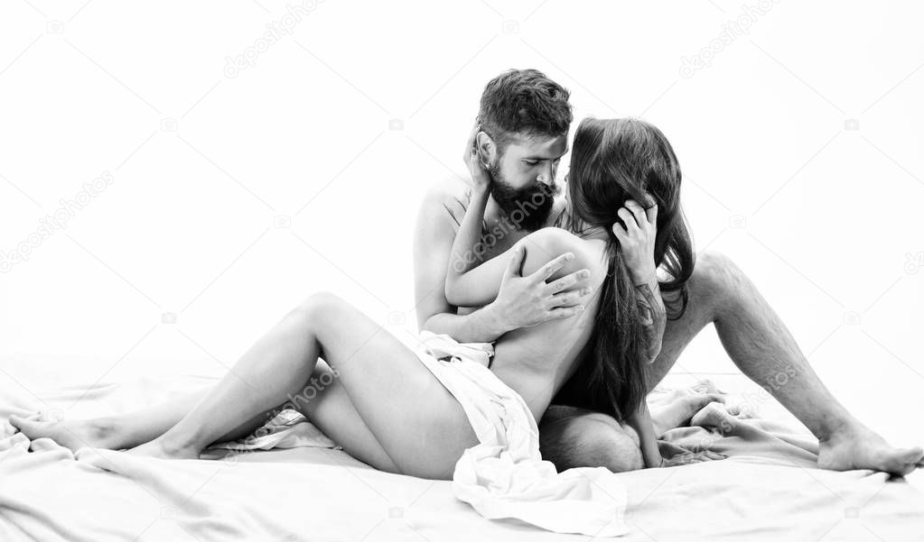 Couple lovers naked hug or cuddling in bed. Art of seduction. Hipster seduce attractive girl. Desire and seduction concept. Couple make love sex. Seductive kiss. Sensual foreplay tease and seduction