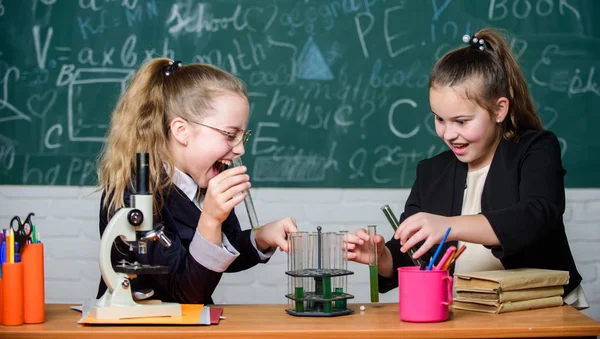 Educational experiment concept. Microscope and test tubes on table. Be careful performing chemical reaction. Basic knowledge of chemistry. Girls study chemistry. Make studying chemistry interesting — Stock Photo, Image