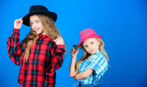 Following sister in everything. Girls kids wear fashionable hats. Small fashionista. Cool cutie fashionable outfit. Happy childhood. Kids fashion concept. Check out our fashion style. Fashion trend — Stock Photo, Image