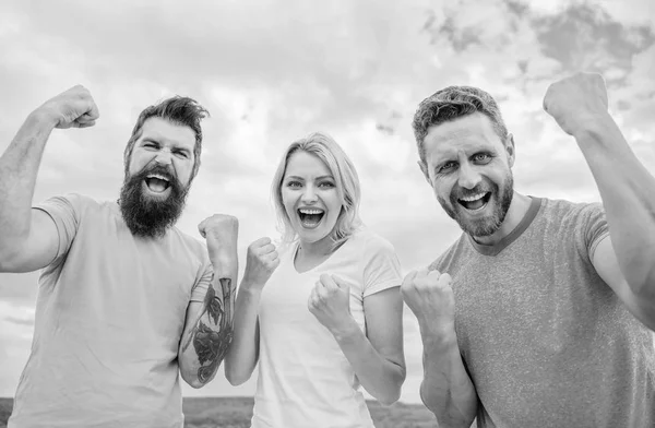 Celebrate success. We can do it. Ways to build successful team. Behaviors of winner team. Woman and men look successful celebrate victory sky background. Threesome stand happy with raised fists