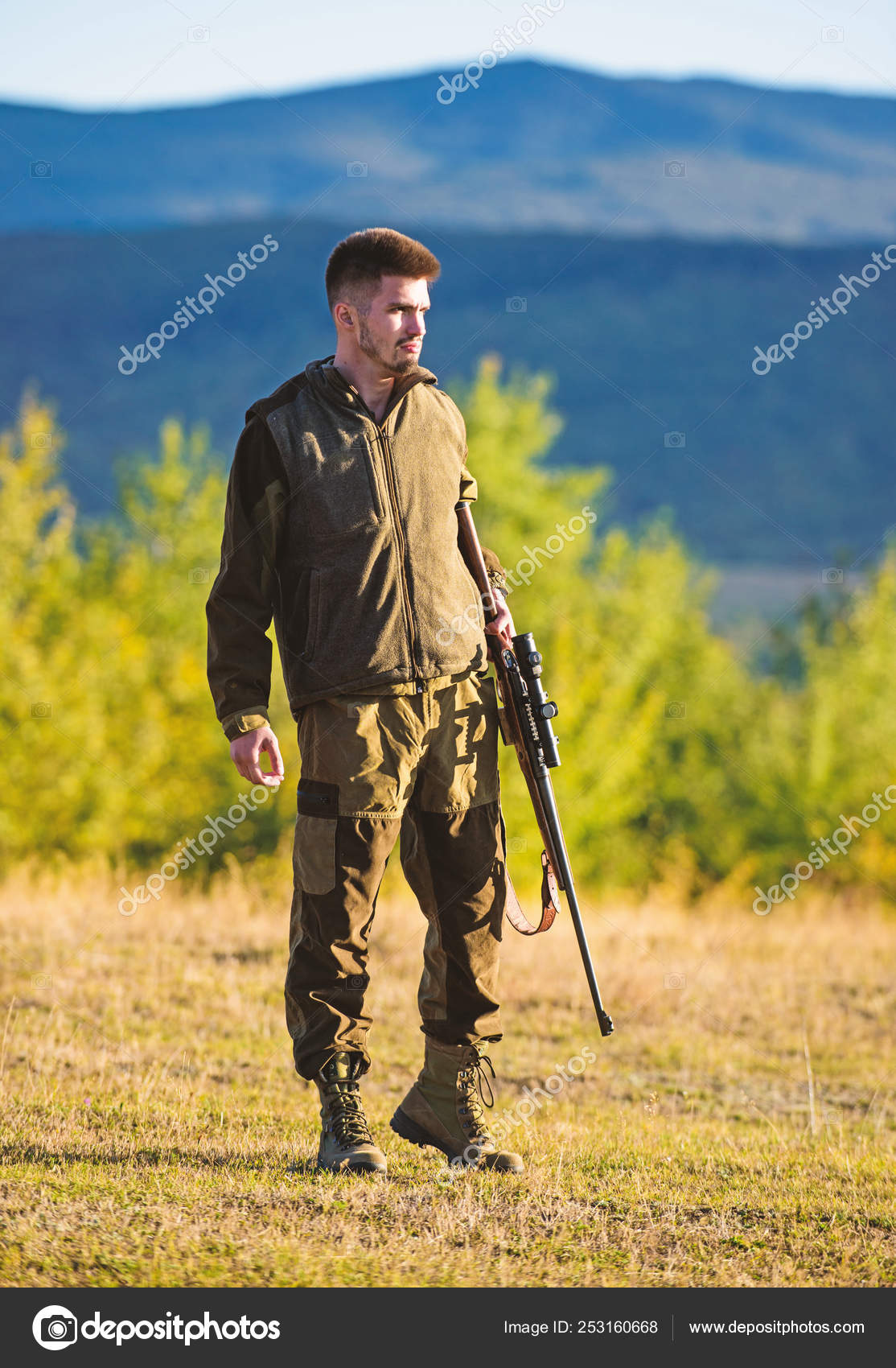 Mental preparation for hunting individual process. Man rifle for hunt.  Hunter khaki clothes ready to hunt hold gun mountains background. Hunter  with rifle looking for animal. Hunting shooting trophy Stock Photo by ©