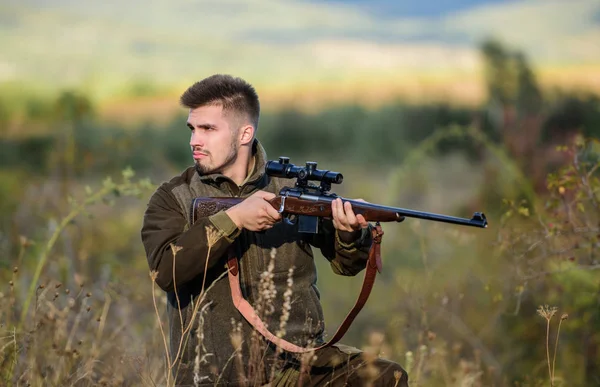 Hunting and trapping seasons. Hunting permit. Man brutal gamekeeper nature background. Bearded hunter spend leisure hunting. Hunter hold rifle. Focus and concentration of experienced hunter — Stock Photo, Image