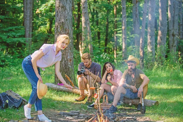 Company friends having hike picnic nature background. Summer picnic. Tourists hikers relaxing while having picnic snack. Picnic with friends in forest near bonfire. Hikers relaxing during snack time