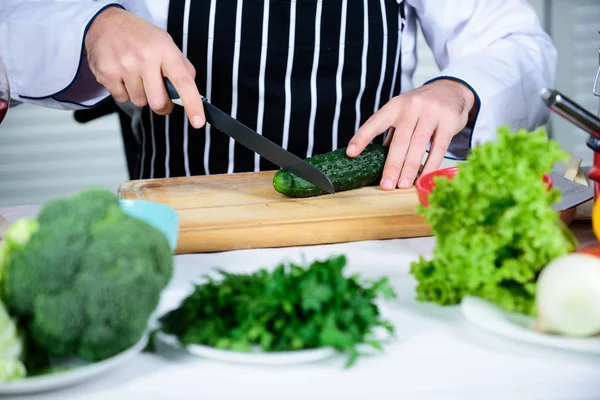 At work. Chef man in apron. Secret taste recipe. Vegetarian. Bearded man cook in kitchen, culinary. Dieting and organic food, vitamin. Healthy food cooking