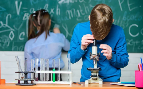 Μικρό αγόρι και κορίτσι στο εργαστήριο. πειράματα βιολογίας με μικροσκόπιο. Παιδάκια κερδίζουν χημεία στο school lab. Χημεία επιστήμη. Μικρά παιδιά. Επιστήμη. Απολαμβάνοντας τη ζωή του Πανεπιστημίου — Φωτογραφία Αρχείου