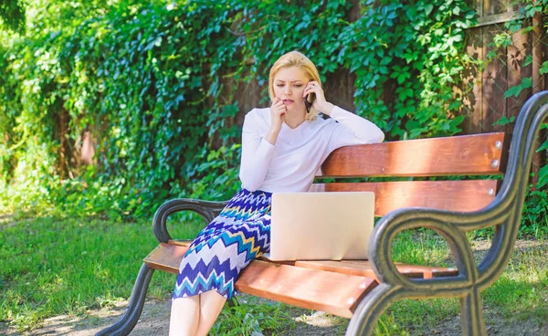 Girl sit bench with notebook call phone. Save your time with virtual shopping. Technologies making life easier. Woman laptop park ordering items virtual shop. Girl take advantage virtual shopping