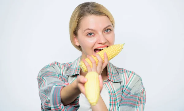 Woman farmer at corn harvest. Farming, farmer girl with maize. Happy woman eating corn. vegetable harvest. corn crop. vitamin and dieting food. agriculture and cultivation. healthy teeth — Stock Photo, Image