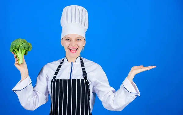 Sehen Sie sich das an. Köchin lächelt mit Vitamin-Brokkoli und gestikuliert weg. glückliche Frau Werbung für frische Vitaminpflanzen. Profi-Koch mit Vitaminkraut. Vitaminprodukt präsentieren, Raum kopieren — Stockfoto