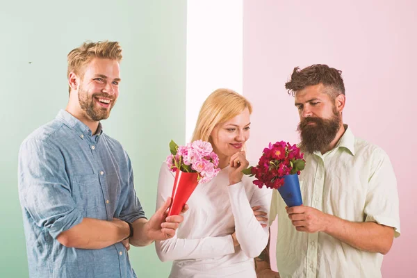 Men competitors with bouquets flowers try conquer girl. Girl likes to be in middle attention. Love triangle. Woman thoughtful has opportunity choose partner. Girl popular receive lot men attention — Stock Photo, Image