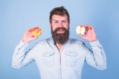 Sağlıklı bir alternatif. Elma hem de sağlıklı alternatif eller. Vitamini beslenme diyet sağlık. Tamamen sağlıklı beslenme kavramı. Sakallı adam gülümseyen elma elinde tutan mavi arka plan