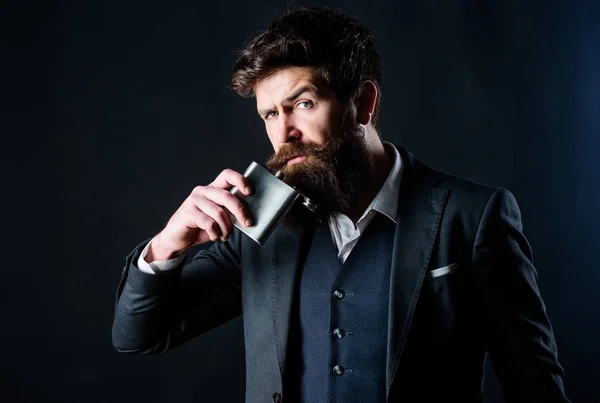 Hangover. Long working day. businessman in suit. brutal caucasian hipster has bad addiction. Mature hipster with beard put flask in pocket. bachelor and single. Bearded man drink alcohol — Stock Photo, Image