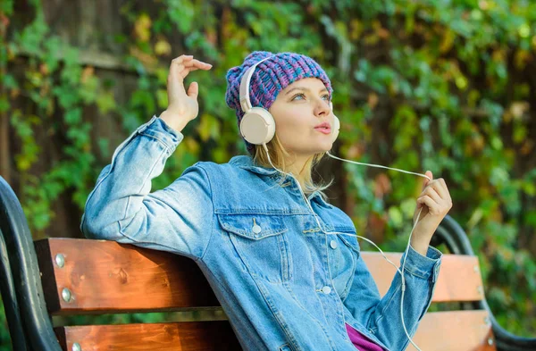 Njut av kraftfullt ljud. Känns awesome. Cool funky tjej njuta av musik i hörlurar utomhus. Flicka lyssna musik i parken. Melody ljud och mp3. Musik fläkt koncept. Hörlurar måste ha moderna gadget — Stockfoto