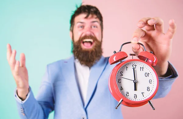 Just in time. Man bearded happy cheerful businessman hold alarm clock. Timely concept. Hipster happy working day is over. Businessman finished on time. Time management skills. Best time of day
