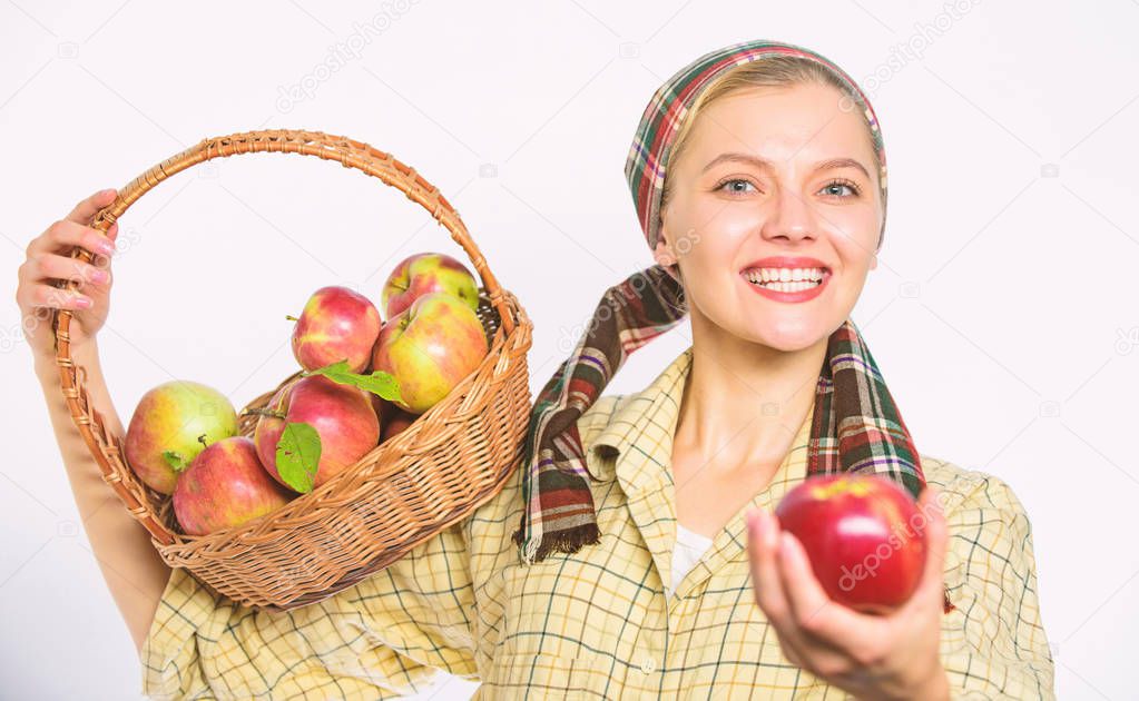 Woman sincere villager carry basket with natural fruits. Lady gardener proud of her harvest. Woman gardener rustic style offer you apple on white background selective focus. Try this ripe juicy apple