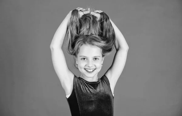 How to make tidy hairstyle for kid. Ballroom latin dance hairstyles. Kid girl with long hair wear dress on red background. Things you need know about ballroom dance hairstyle. Hairstyle for dancer — Stock Photo, Image