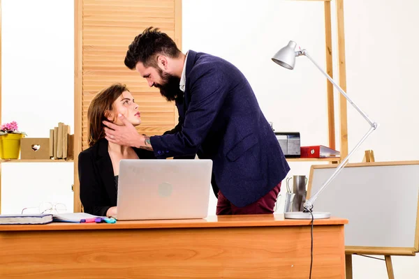 Forming close bonds with workmate. Workplace affair. Boss and secretary having sweet affair. Love affair of bearded man and sexy woman in office. Couple in love conducting affair at work