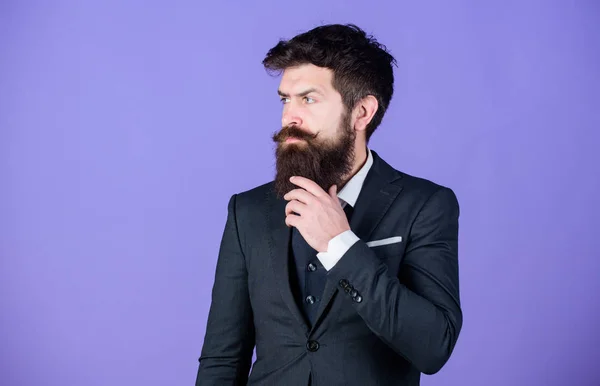 Fashion concept. Guy wear formal outfit. Impeccable style. Businessman fashionable outfit stand violet background. Man bearded hipster wear classic suit outfit. Formal outfit. Elegancy and male style