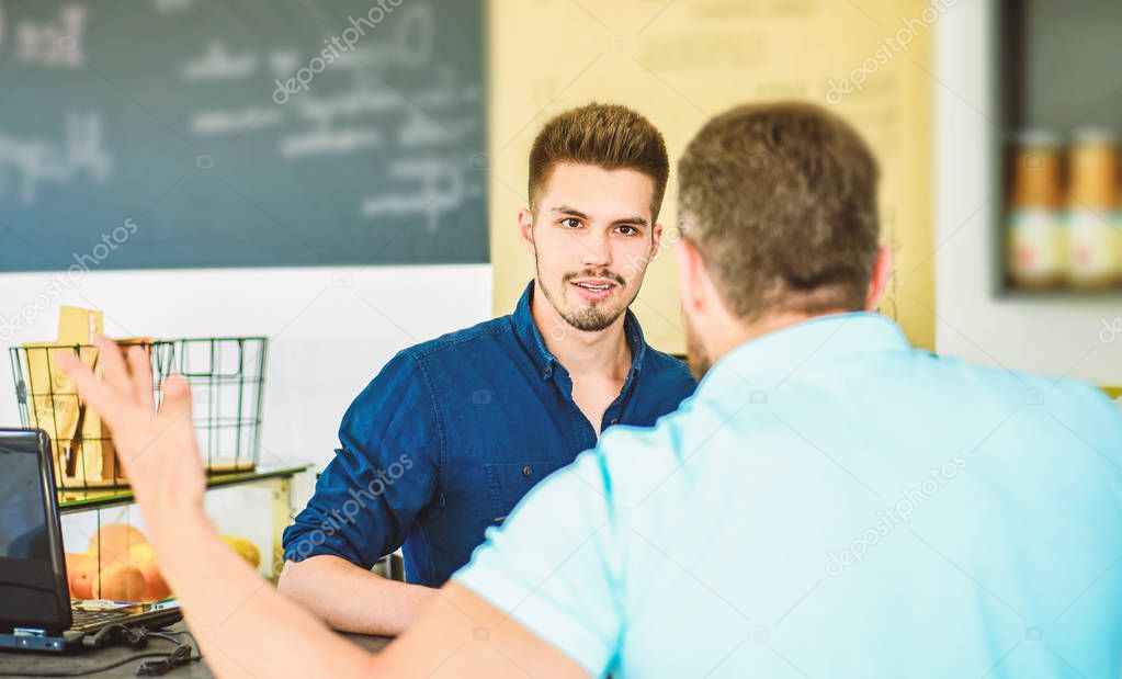 Do you need problems. Man client emotional arguing with staff person. Unsatisfied visitor angry about service. Man yelling at barista guy stand on background. Client dislike drink. Arguing in public