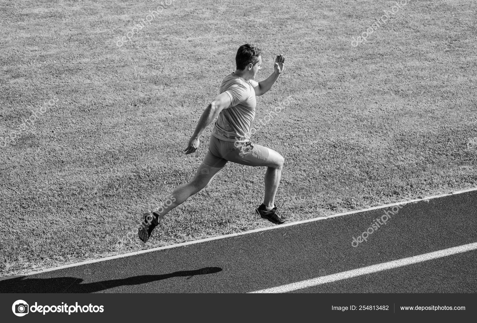 Athlete run track grass Sprinter training at stadium
