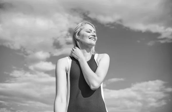 Meisje speelse sfeer coquette. Flirt en coquette concept. Zonlicht aangenaam warm. Vrouw rode jurk voelt onbezorgd en vrij. Blonde dame meisje glimlachend genieten van warm zonlicht blauwe hemel met wolken achtergrond — Stockfoto