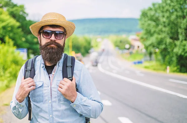 Looking for company. Look for fellow travelers. Tips of experienced tourist. Man bearded hipster tourist at edge of highway. Tourist waiting for car take him anyway just drop at better spot