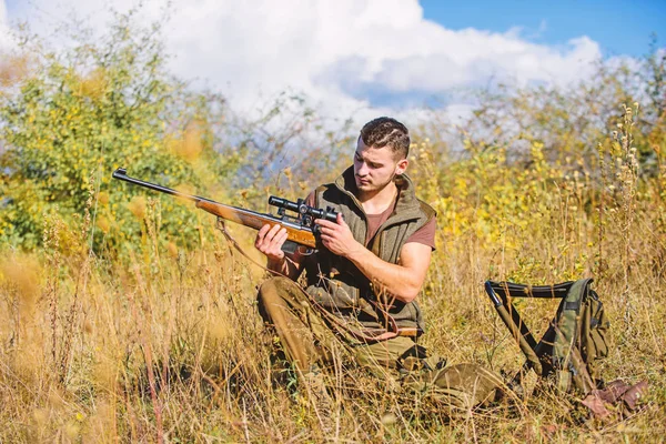 Hunting strategy or method for locating targeting and killing targeted animal. Man hunting wait for animal. Hunter with rifle ready to hunting nature background. Hunting skills and strategy