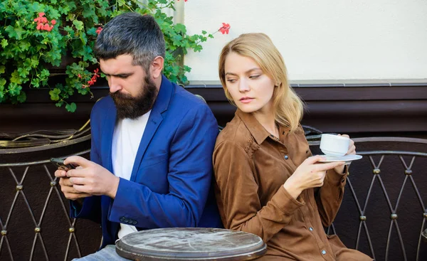 Quick chat at the morning. woman and man with beard relax in cafe. First meet of girl and mature man. Brutal bearded hipster and girl drink coffee. Morning coffee. Couple in love on romantic date