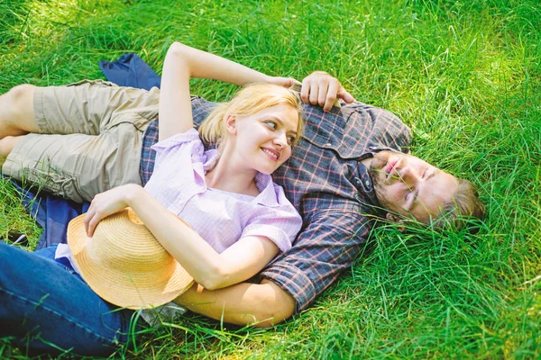 Couple in love relaxing outdoors. Guy and girl dreamy relaxed enjoy tranquility nature. Nature fills them with tranquility and peace. Man unshaven and girl relax on grass meadow. Take minute to relax — Stock Photo, Image