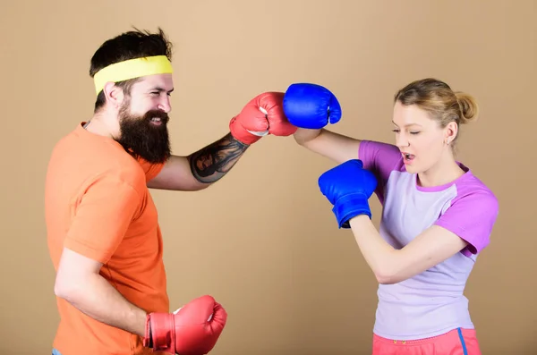 Punching, sport Success. sportswear. Fight. knockout and energy. couple training in boxing gloves. Happy woman and bearded man workout in gym. training with coach. Make your competitive juices — Stock Photo, Image