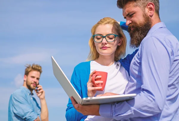 Fresh air helps to refresh mind. Colleagues laptop work outdoor sunny day, sky background. Outdoor workspace concept. Colleagues with laptop discussing plan. Friends enjoy fresh air and keep working