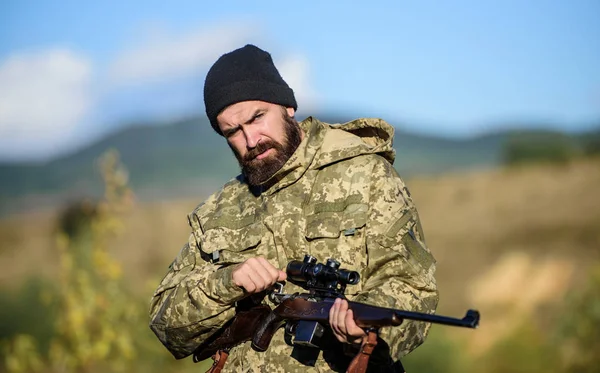 Hunter hold rifle. Focus and concentration of experienced hunter. Hunting and trapping seasons. Hunting masculine hobby. Man brutal gamekeeper nature background. Bearded hunter spend leisure hunting — Stock Photo, Image