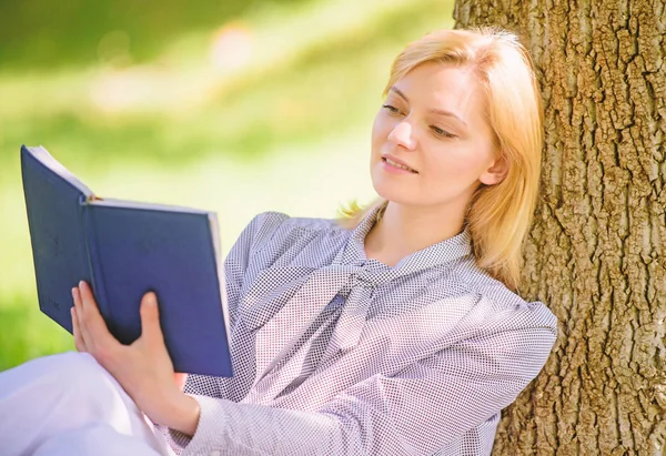 Girl lean on tree while relax in park sit grass. Self improvement book. Self improvement and education concept. Business lady find minute to read book improve her knowledge. Female self improvement
