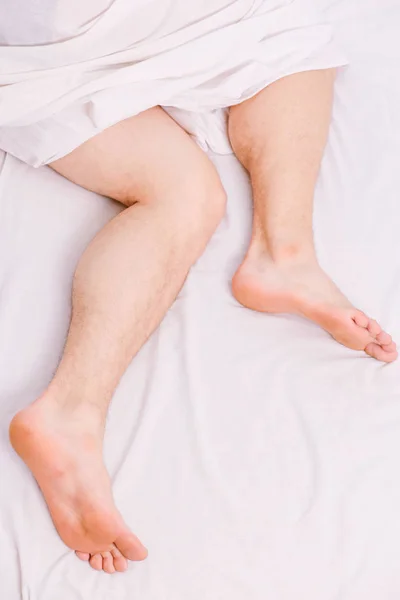 Cheerful young man is waking up after sleeping in the morning. Man eyes are closed with relaxation. The routine. — Stock Photo, Image