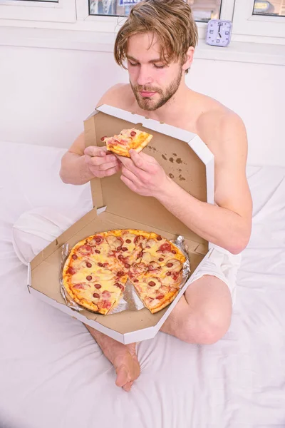 Guy naked covered pizza box sit bed bedroom offer you join him. Sexy courier delivers gastronomic satisfaction. Gastronomic satisfaction. Man bearded handsome eat pizza. Man eat pizza breakfast