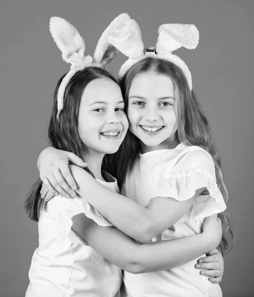 Spring holiday. Happy childhood. Friendship concept. Easter vibes. Happy easter. Holiday bunny girls with long bunny ears hug. Children easter bunny costume. Playful girls sisters celebrate easter — Stock Photo, Image