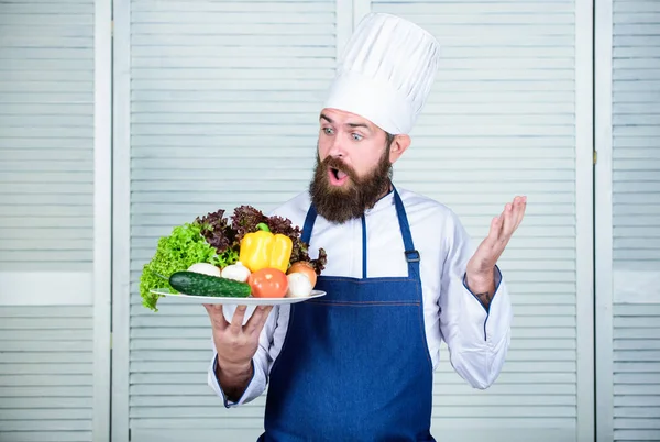 surprised bearded man. chef recipe. Cuisine culinary. Vitamin. Vegetarian salad with fresh vegetables. Dieting organic food. Healthy food cooking. Mature hipster with beard. Ask for advice