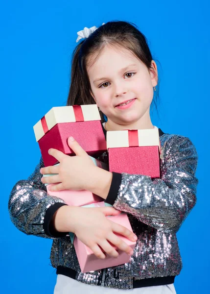 Shop for what you want. Girl with gift boxes blue background. Black friday. Shopping day. Child carry lot gift boxes. Kids fashion. Surprise gift box. Birthday wish list. Special happens every day