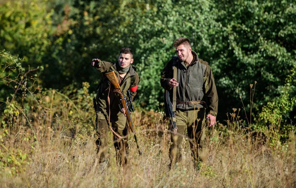 Activity for real men concept. Hunters gamekeepers looking for animal or bird. Hunting with friends. Hunters friends enjoy leisure. Hunters with rifles in nature environment. Teamwork and support — Stock Photo, Image