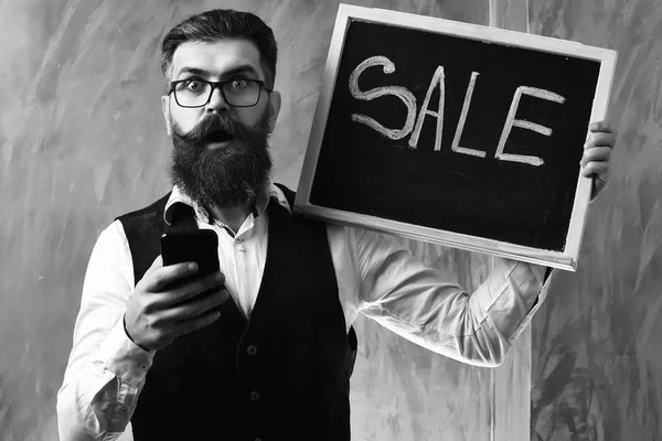 Hombre barbudo, brutal hipster caucásico con inscripción de venta de teléfonos inteligentes —  Fotos de Stock