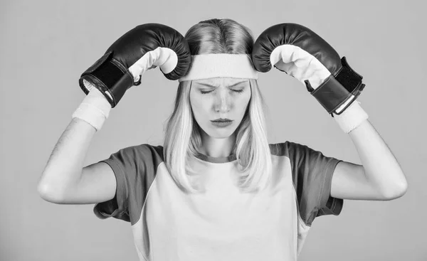 Keep calm and get rid of headache. Beat headache. Girl boxing gloves tired to fight. Strong woman suffer pain. Girl painful face embrace head with boxing gloves. Headache remedies. Headache concept — Stock Photo, Image